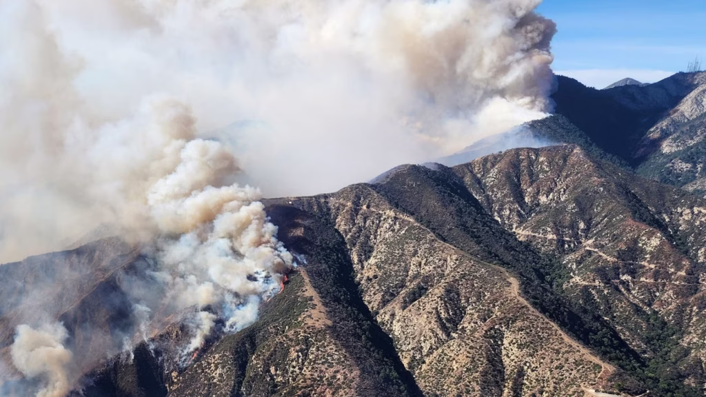 A photo of the smoke billowing over mountains